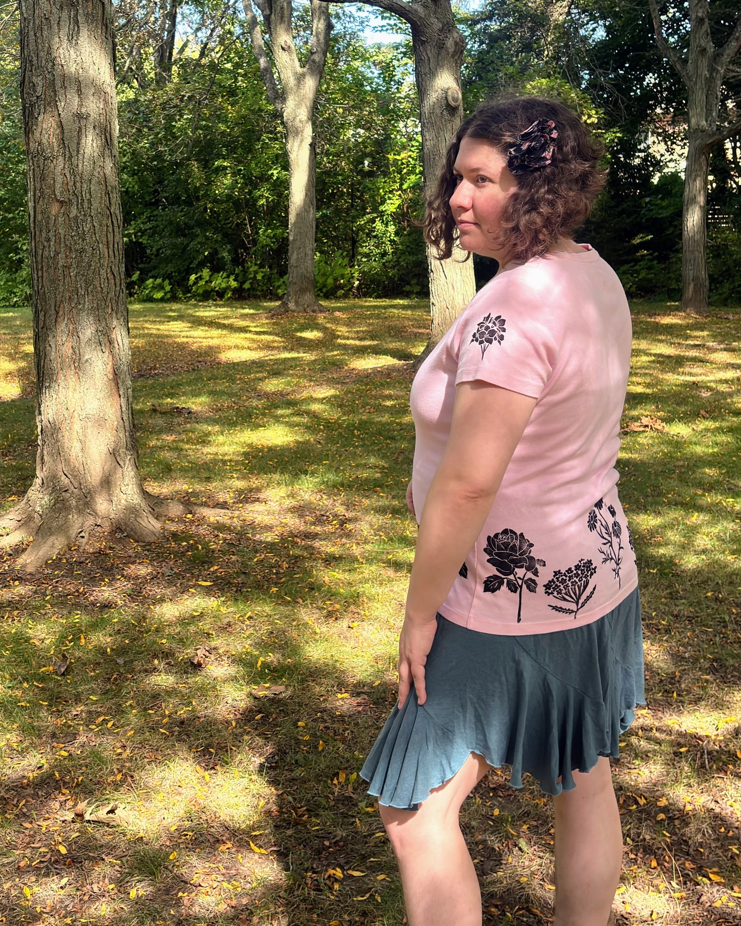 Free & Wild; pink short sleeve t-shirt featuring roses and wildflowers