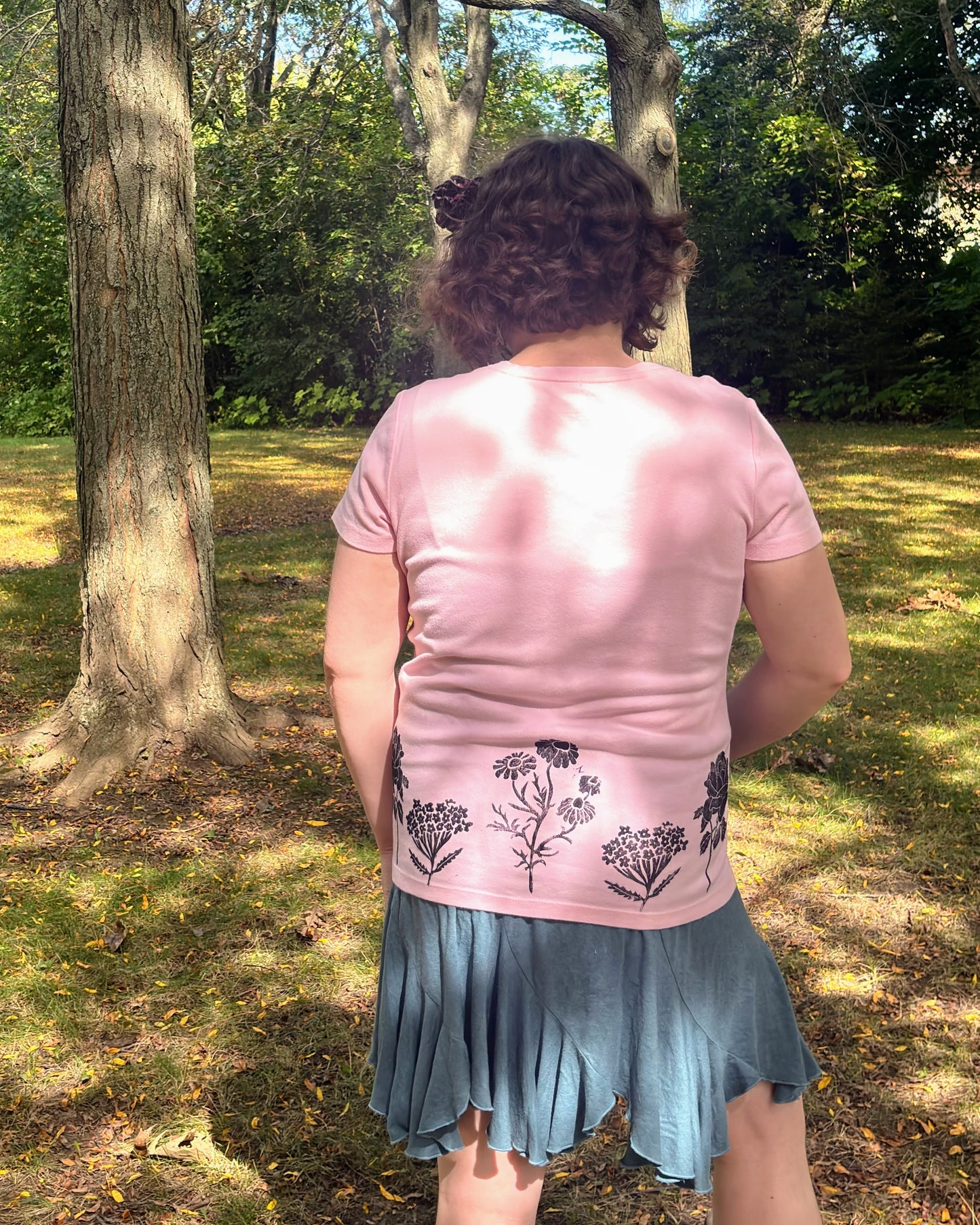 Free & Wild; pink short sleeve t-shirt featuring roses and wildflowers