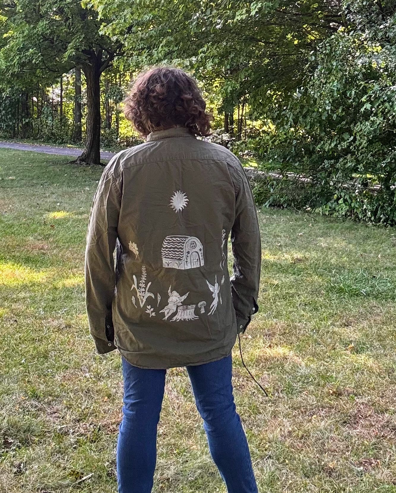 Fairy Cottage Fantasy; long sleeve olive green shirt featuring moon phases, fairies, and wildflowers