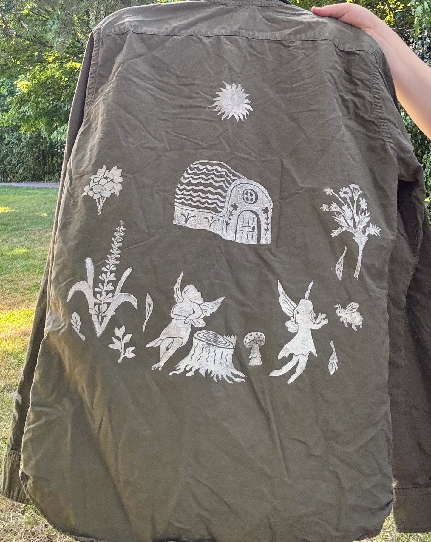 Fairy Cottage Fantasy; long sleeve olive green shirt featuring moon phases, fairies, and wildflowers